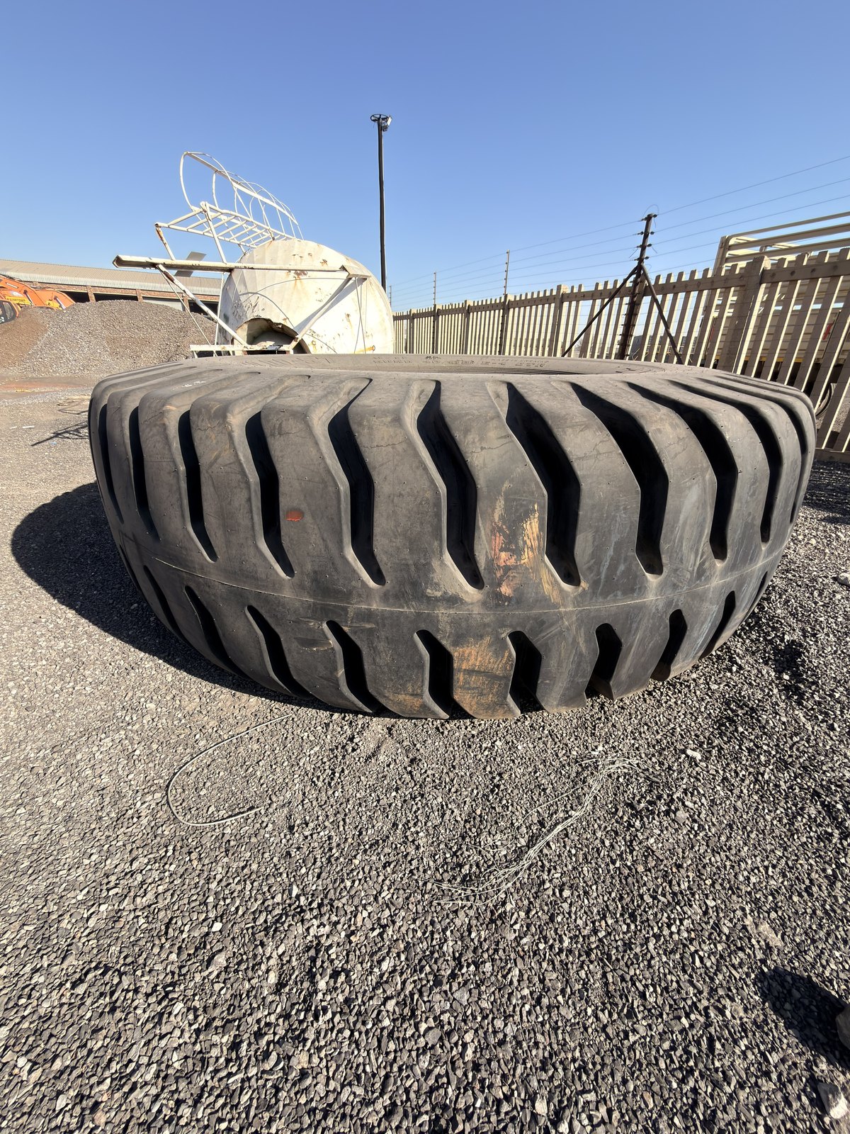 Single earthmover tyre from the side, tread blocks and bead in view