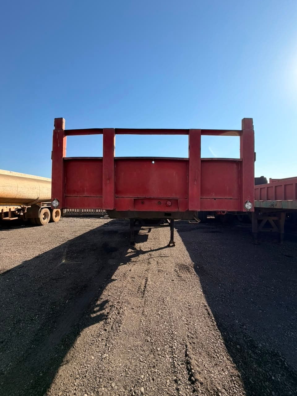Used 12m flat deck trailer, head-on view of the stanchion headboard and the deck behind it
