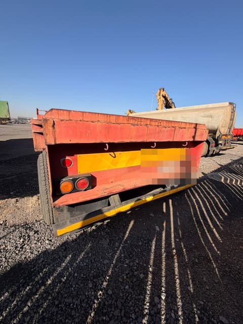 Used 12m flat deck trailer, rear view of the deck, tail lights and chevron plate