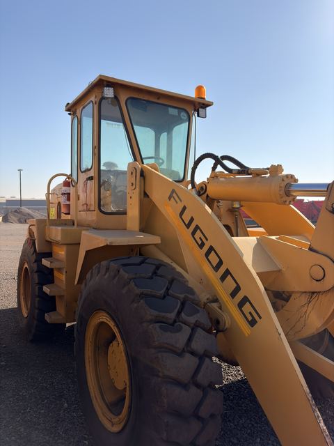 Used Fugong front end loader, front three-quarter view of the cab and lift arm