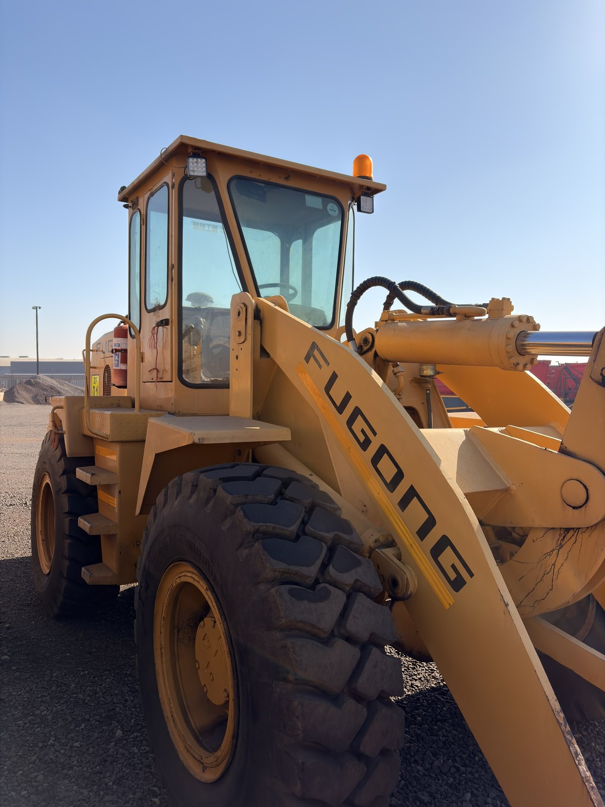 Used Fugong front end loader, front three-quarter view of the cab and lift arm
