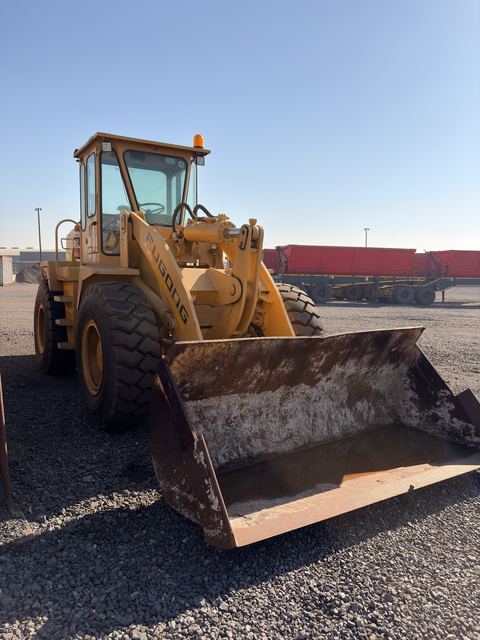 Used Fugong front end loader, front three-quarter view with the bucket resting on the ground