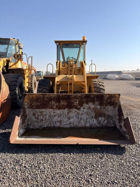Used Fugong front end loader, head-on view with the bucket flat on the ground