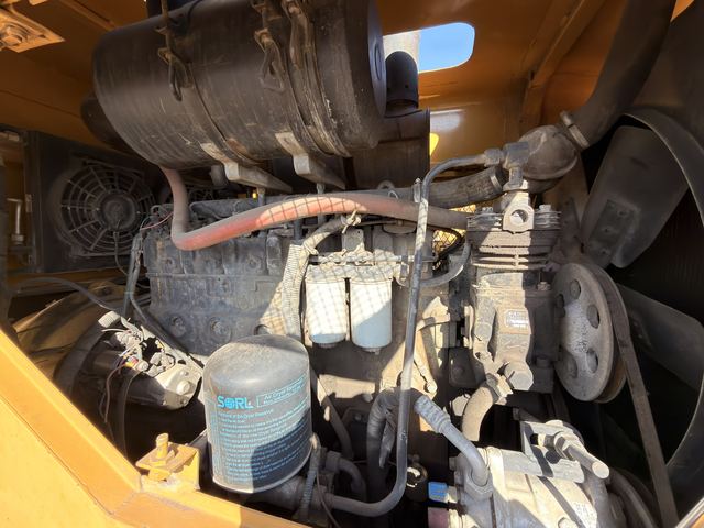 The engine bay of the used Fugong front end loader, filter and belt side