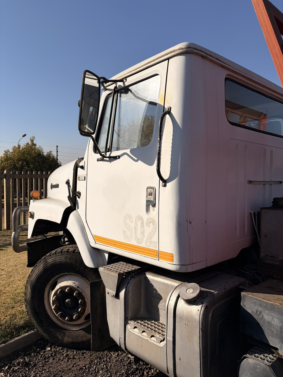 Used International skip loader truck, cab side and door lettering