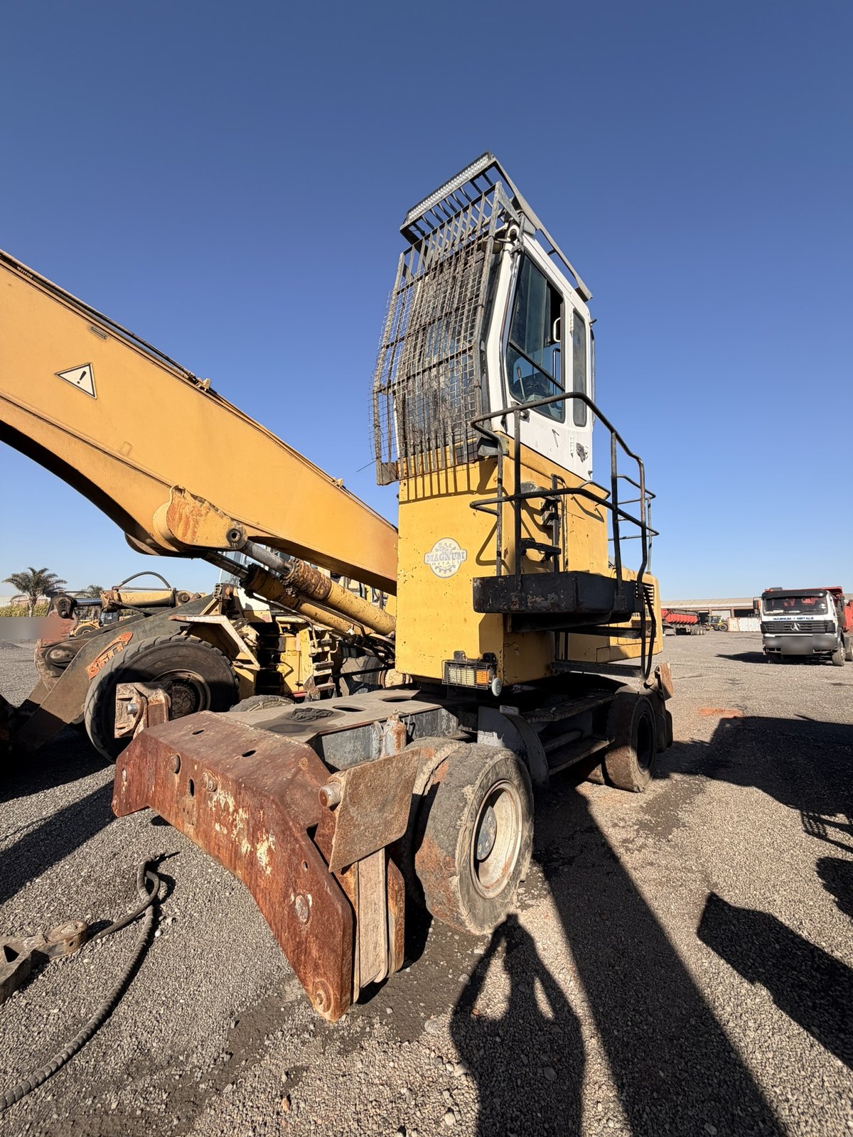 Used Liebherr 924 material handler, front three-quarter view with the boom folded over the cab