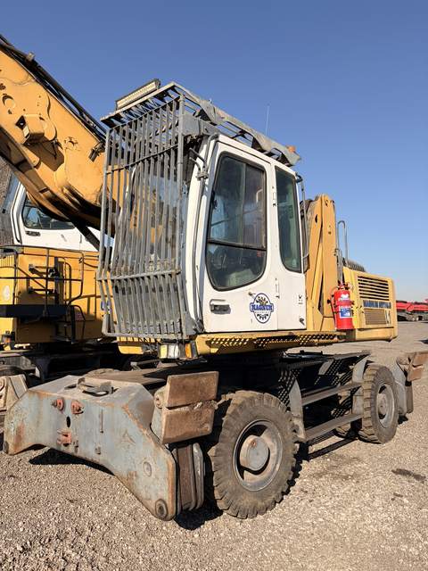 Used Liebherr 924 material handler, rear three-quarter view of the cab and undercarriage