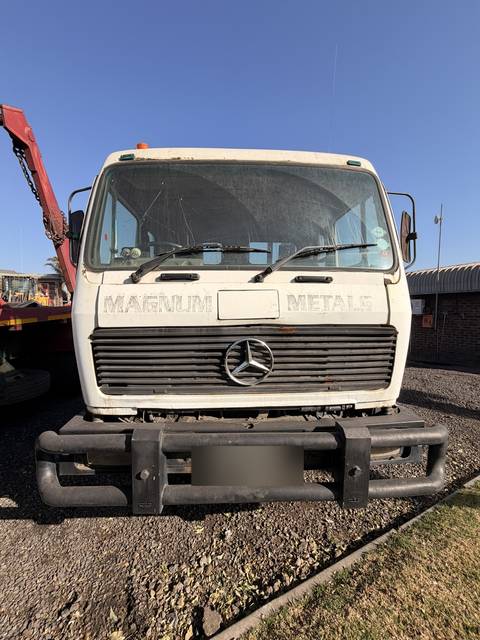 Used Mercedes skip loader truck, head-on view of the cab, grille and bull bar