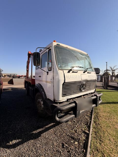 Used Mercedes skip loader truck, front three-quarter view of the cab and bull bar