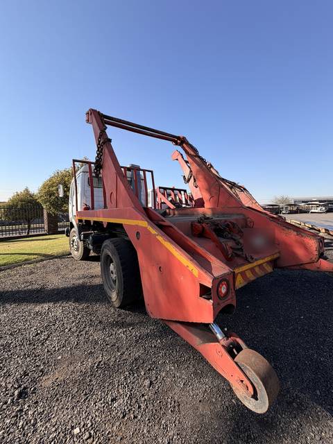 Used Mercedes skip loader truck, rear three-quarter view of the skip-loading gear