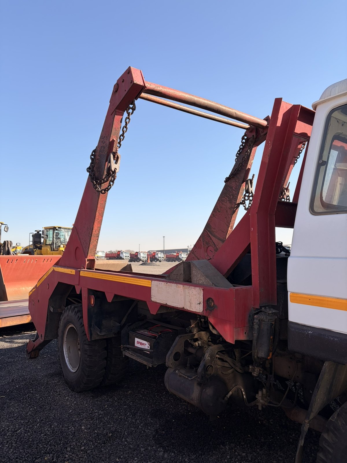 Used Nissan Diesel skip loader truck, close view of the rear skip frame and roller bar