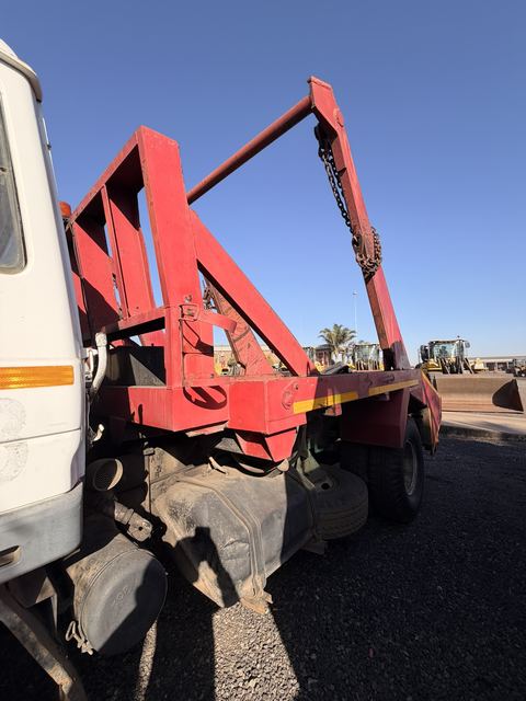 Used Nissan Diesel skip loader truck, side view of the skip arms above the deck