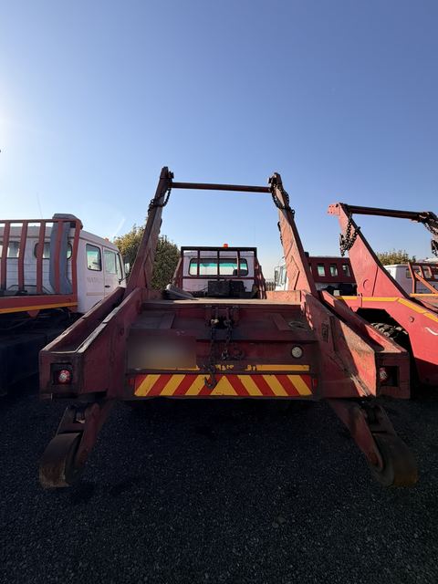 Used Nissan Diesel skip loader truck, rear view of the deck and skip-loading gear