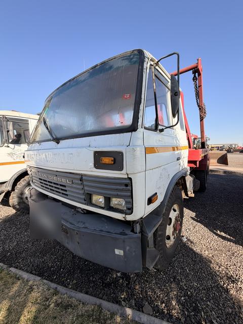 Used Nissan Diesel skip loader truck, front three-quarter view of the cab from the driver's side