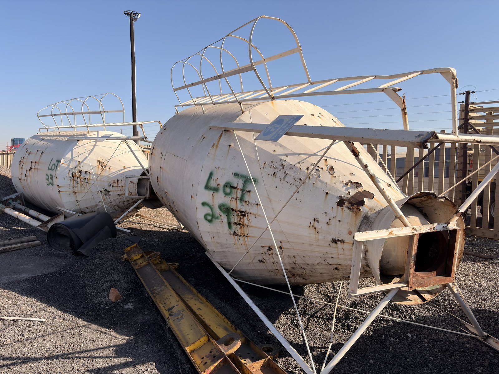 Two used storage silos lying side by side in the yard