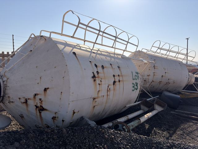 Two used silo bodies lying on the yard, ladder cages uppermost