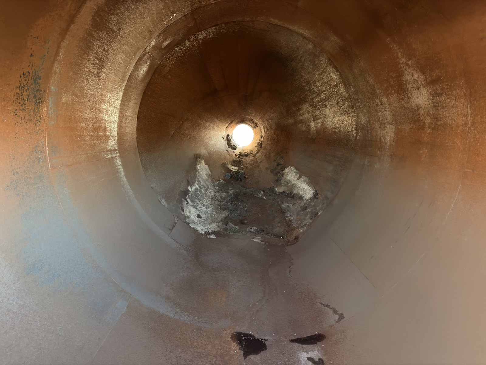Looking down the inside of a used silo barrel from the open end