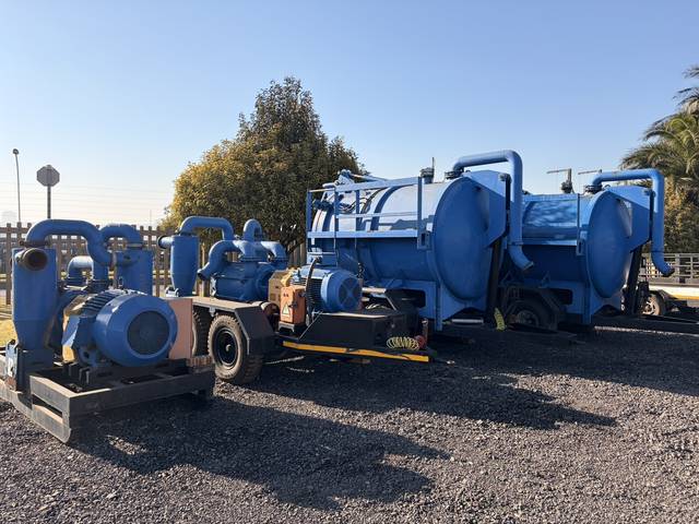 The slurry pump lot: skid-mounted pumps and vacuum tankers standing together