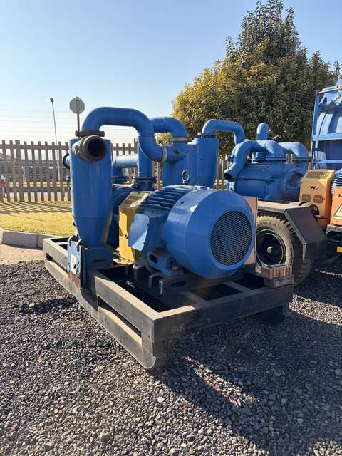 Used skid-mounted slurry pump, three-quarter view on the yard apron