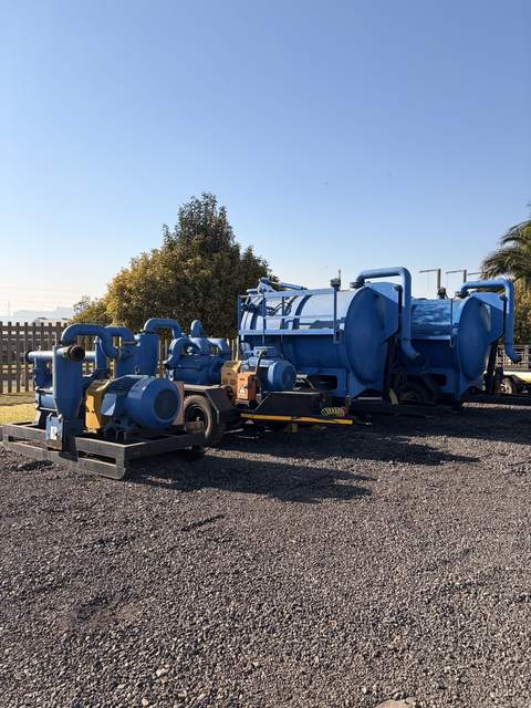The slurry pump lot seen along the yard apron, pumps in front and the blue vacuum tankers behind