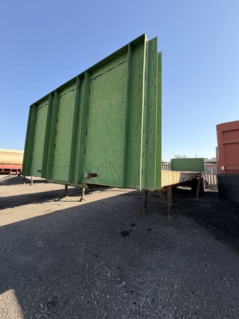 Used 12m trailer with high steel sides, three-quarter view of the high steel sides with the deck running back