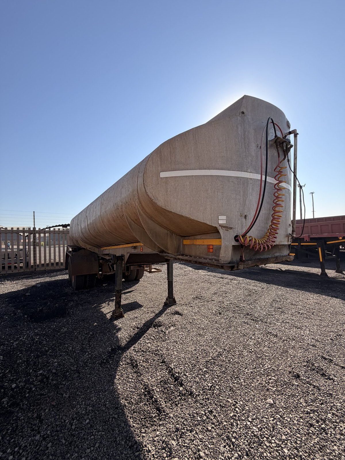 Used water tanker, nearside three-quarter view of the tank barrel standing on its landing legs