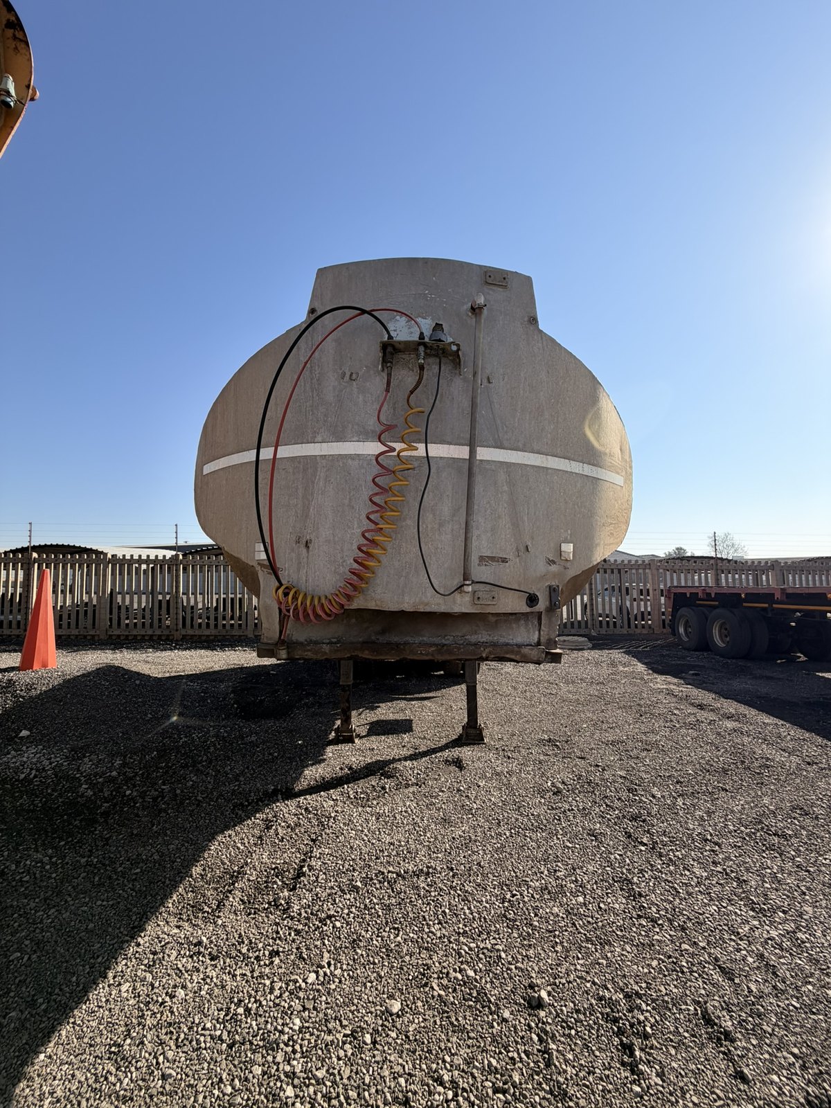 Used water tanker, front-on view of the tank barrel and headboard