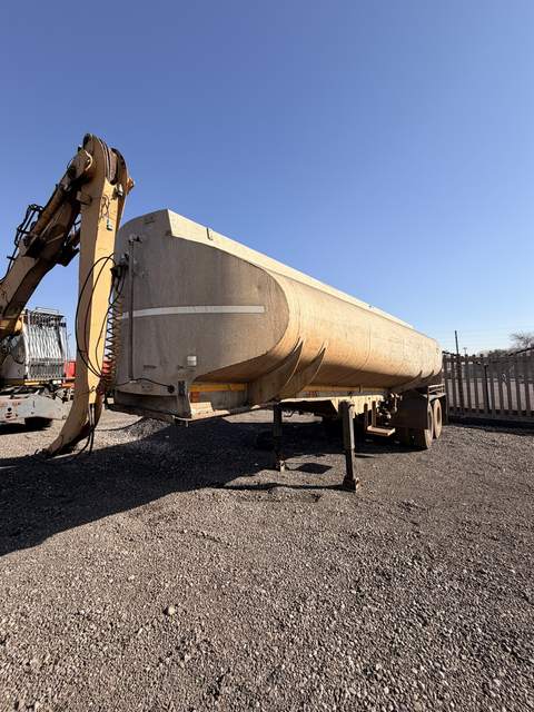 Used water tanker, full side view of the tank standing in the consignment yard